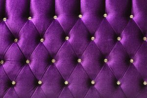 Background of purple Velvet / fabric modern sofa in close up.